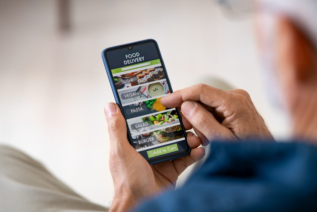 Man using mobile app to order delivery food Variety 